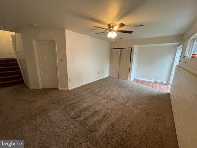 spare room with carpet floors and ceiling fan