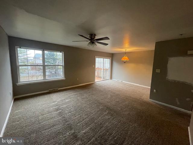 unfurnished room with ceiling fan and carpet flooring