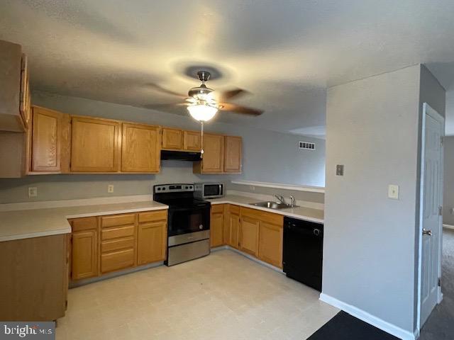 kitchen featuring ceiling fan, appliances with stainless steel finishes, and sink