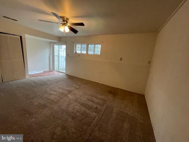 spare room featuring carpet floors and ceiling fan