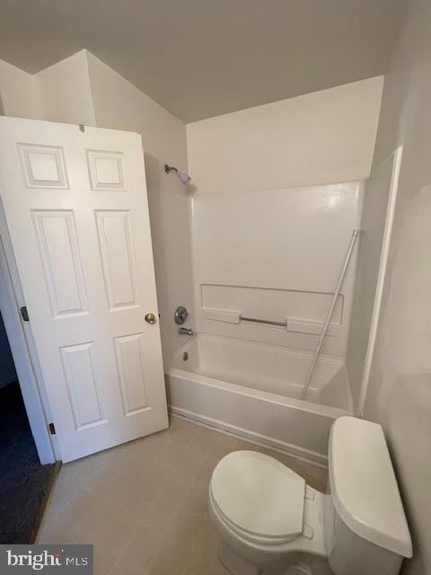 bathroom featuring bathtub / shower combination and toilet