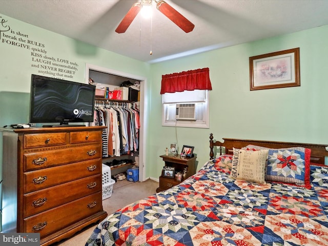 bedroom with cooling unit, ceiling fan, a textured ceiling, light colored carpet, and a closet