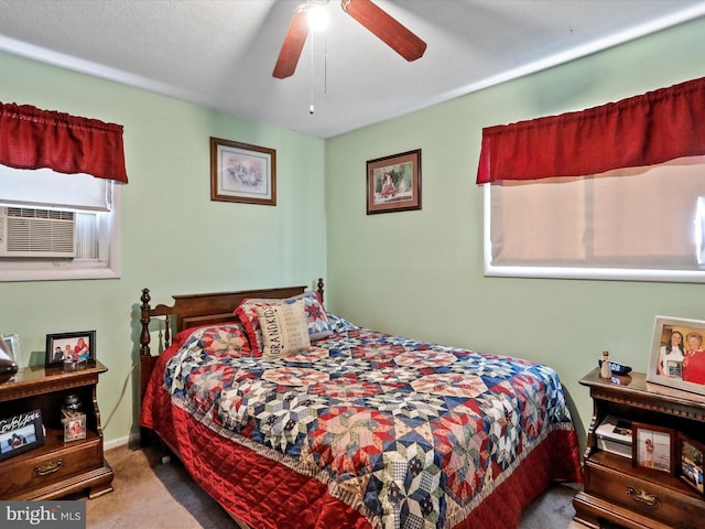 carpeted bedroom with ceiling fan and cooling unit