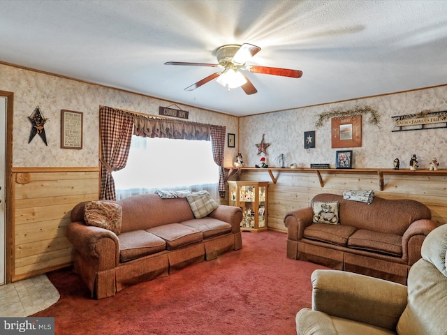 carpeted living room featuring ceiling fan, a textured ceiling, and ornamental molding