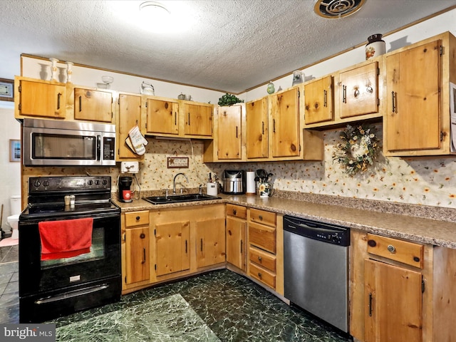 kitchen with decorative backsplash, sink, a textured ceiling, and appliances with stainless steel finishes