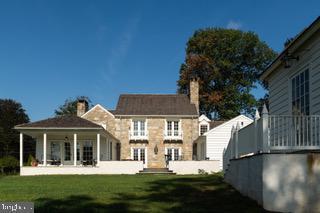 rear view of house with a yard