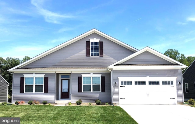 view of front of house featuring a front yard and a garage