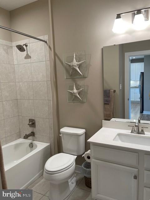 full bathroom with tile patterned flooring, vanity, toilet, and tiled shower / bath