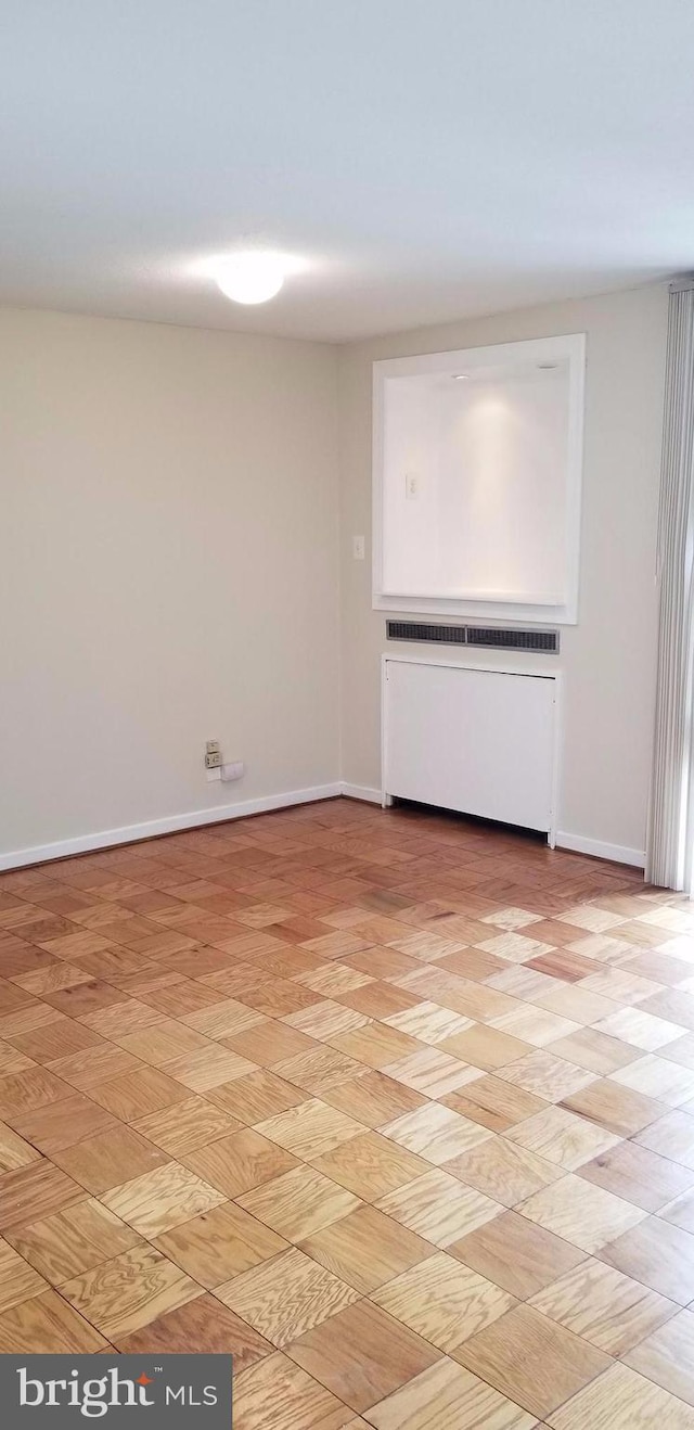 empty room featuring light hardwood / wood-style floors and radiator