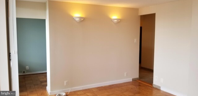 spare room with hardwood / wood-style flooring