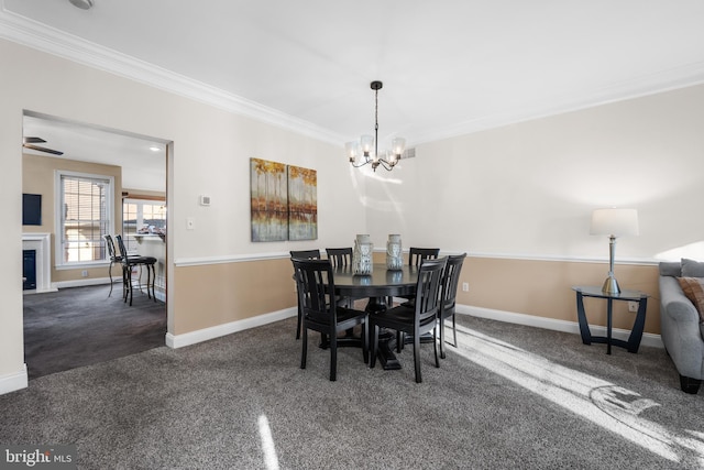 dining area featuring dark colored carpet, ornamental molding, and a chandelier