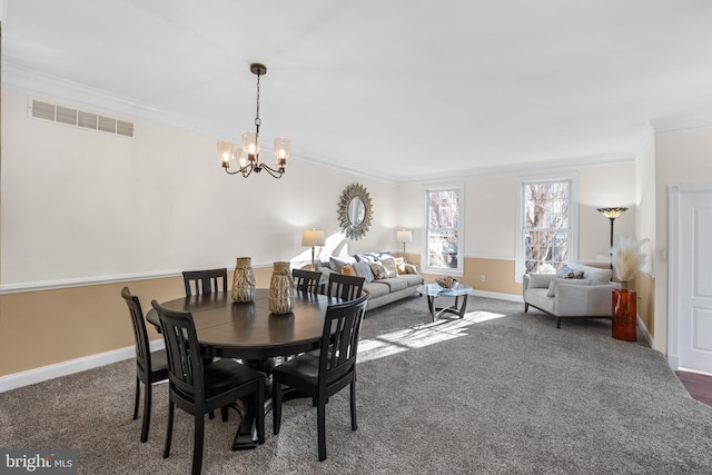 dining room with crown molding, dark carpet, and a notable chandelier