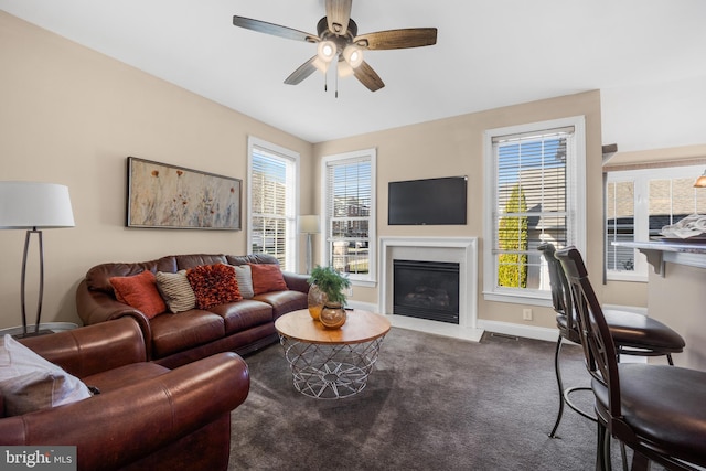 carpeted living room featuring a wealth of natural light and ceiling fan