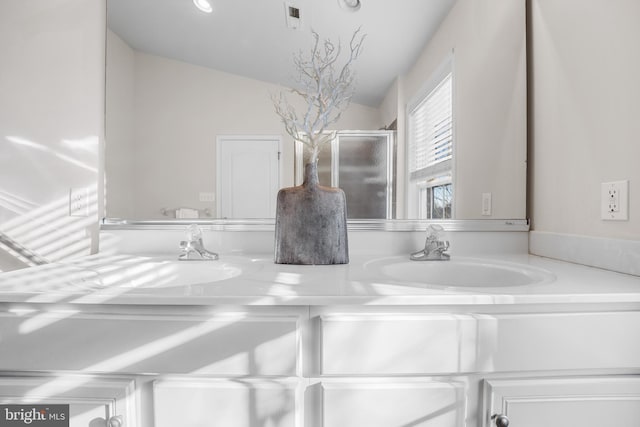 bathroom with vanity and vaulted ceiling