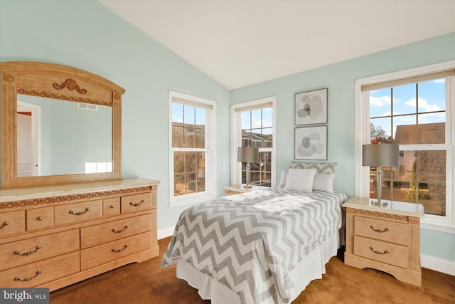 carpeted bedroom featuring multiple windows and lofted ceiling