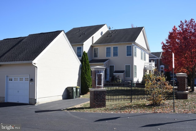 view of side of home with a balcony and a garage