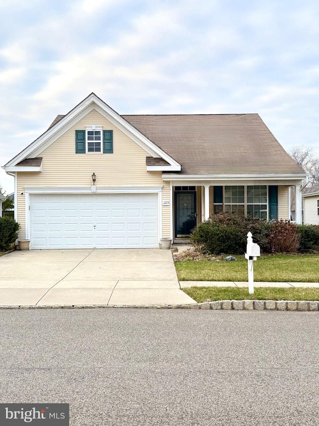 ranch-style house featuring a garage and a front lawn