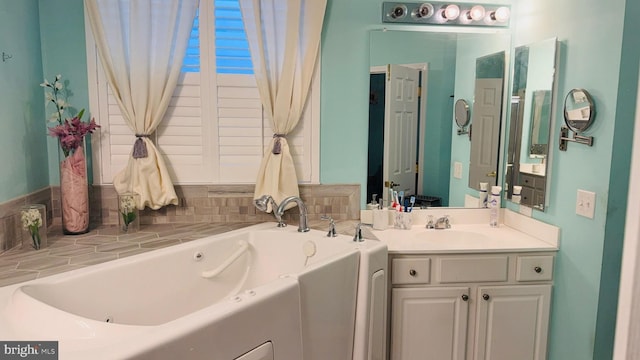 bathroom with vanity and a bath