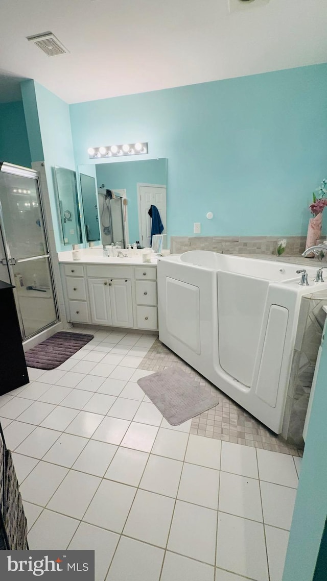 bathroom featuring tile patterned floors, independent shower and bath, and vanity