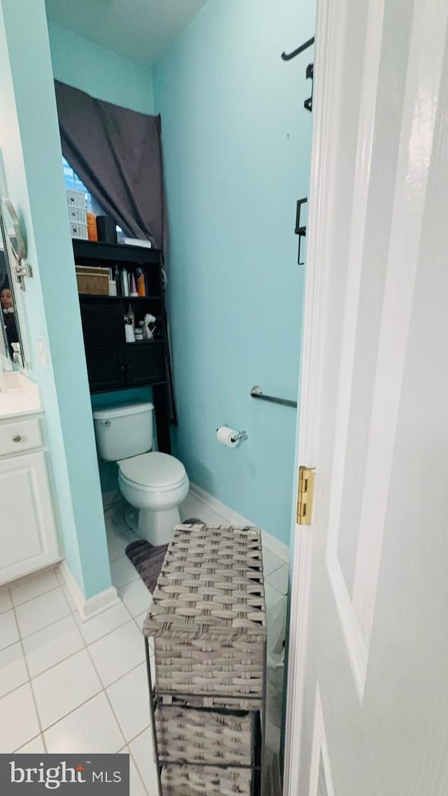 bathroom with vanity, tile patterned floors, and toilet