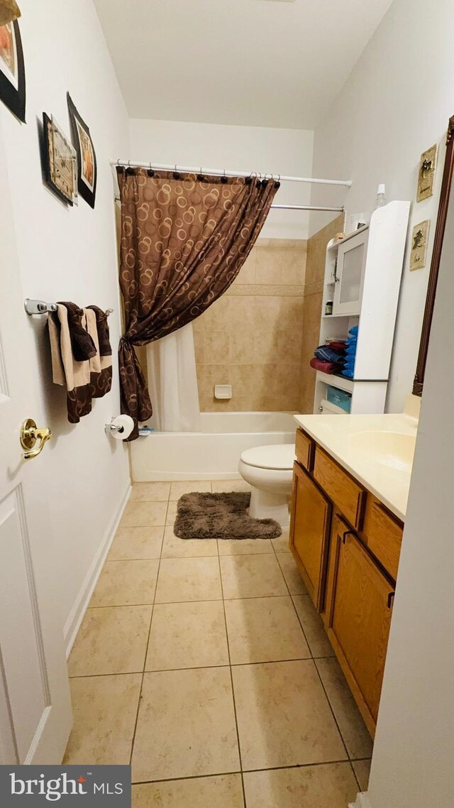 full bathroom with tile patterned flooring, vanity, shower / bath combo, and toilet