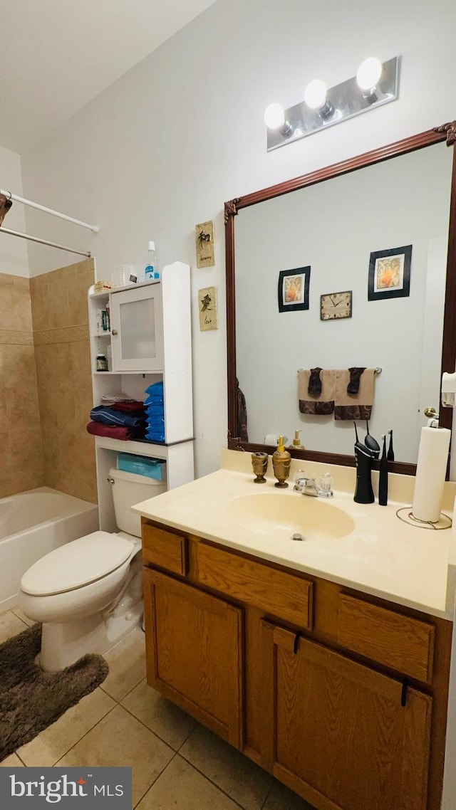 full bathroom featuring vanity, tiled shower / bath, tile patterned floors, and toilet