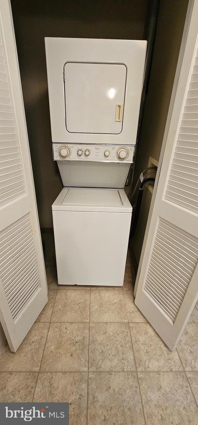 laundry area with stacked washer and clothes dryer