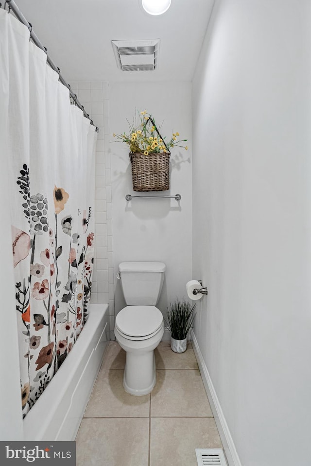 bathroom featuring tile patterned floors, shower / bathtub combination with curtain, and toilet