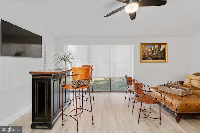 living room with ceiling fan and light wood-type flooring