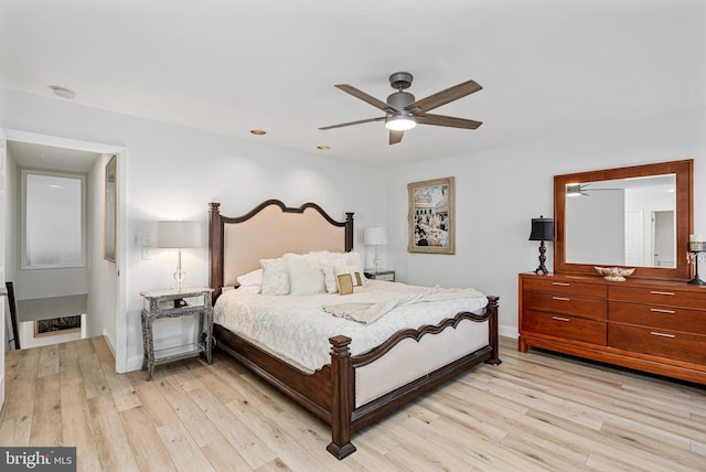 bedroom with ceiling fan and light hardwood / wood-style flooring