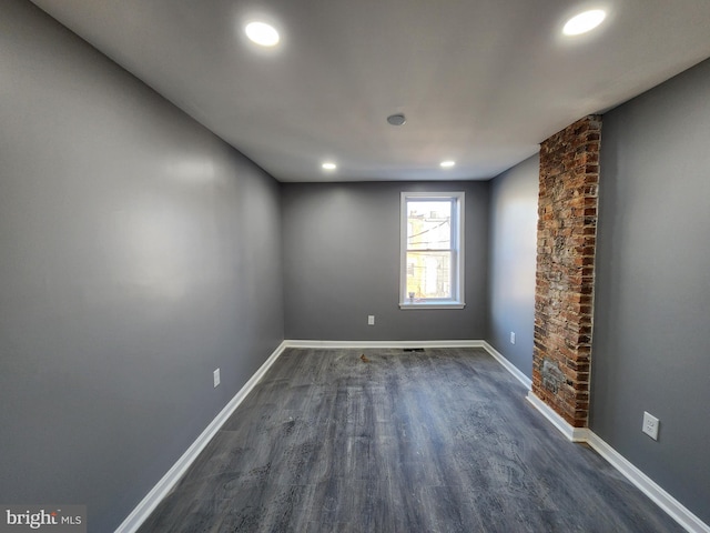 spare room featuring dark wood-type flooring