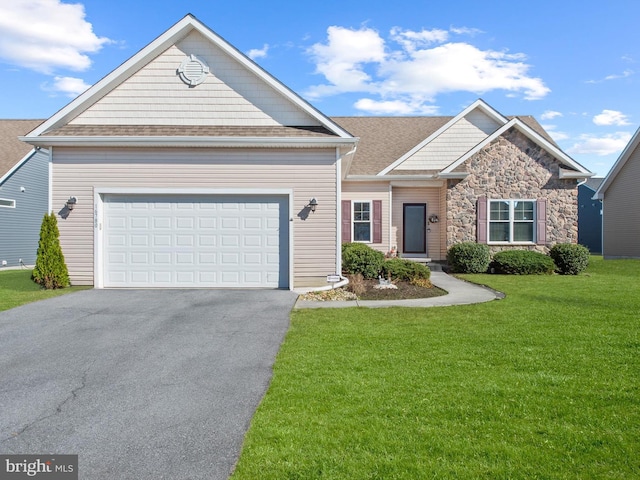 view of front of home with a garage and a front lawn