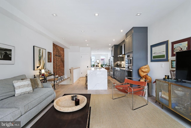 living room with light wood-type flooring and sink