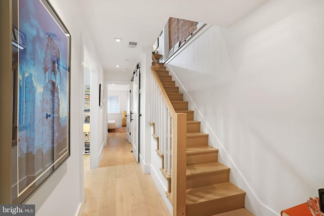 interior space featuring a barn door and wood-type flooring