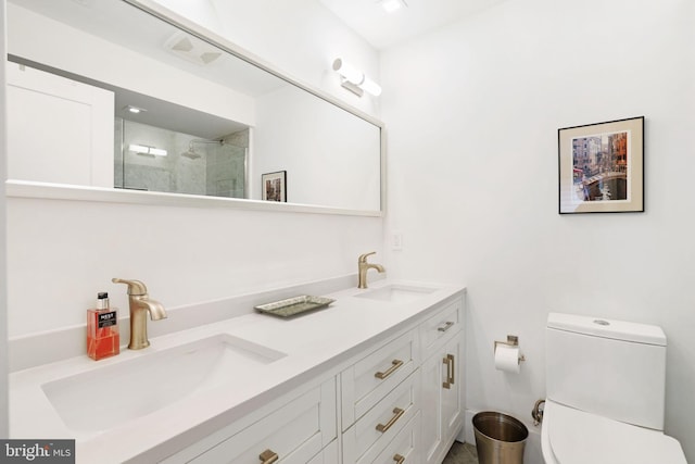 bathroom featuring vanity, an enclosed shower, and toilet