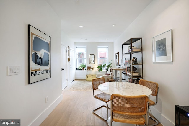 hallway with light hardwood / wood-style floors