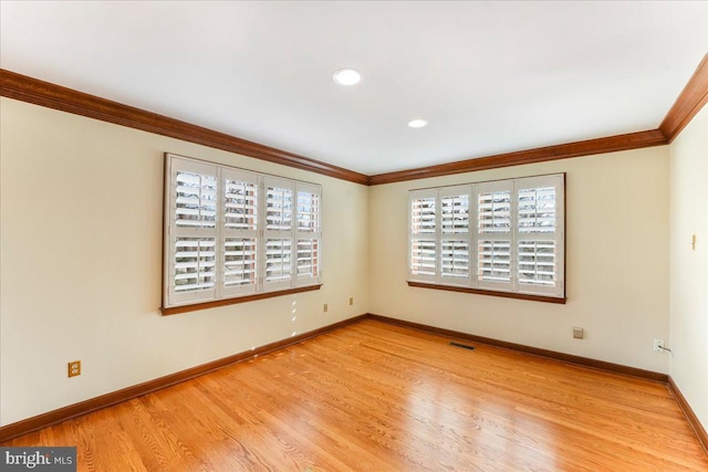 unfurnished room featuring light hardwood / wood-style flooring and ornamental molding