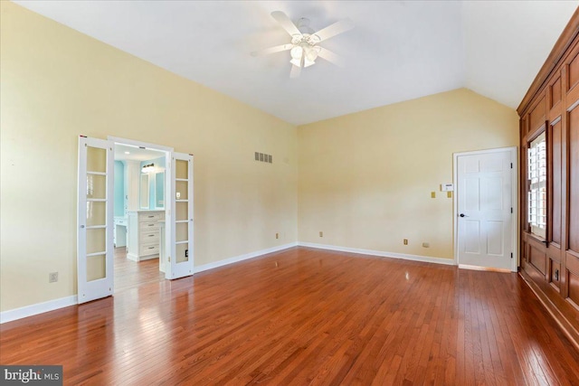 unfurnished room with vaulted ceiling, ceiling fan, dark hardwood / wood-style flooring, and french doors