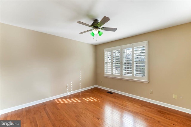 unfurnished room with hardwood / wood-style flooring and ceiling fan