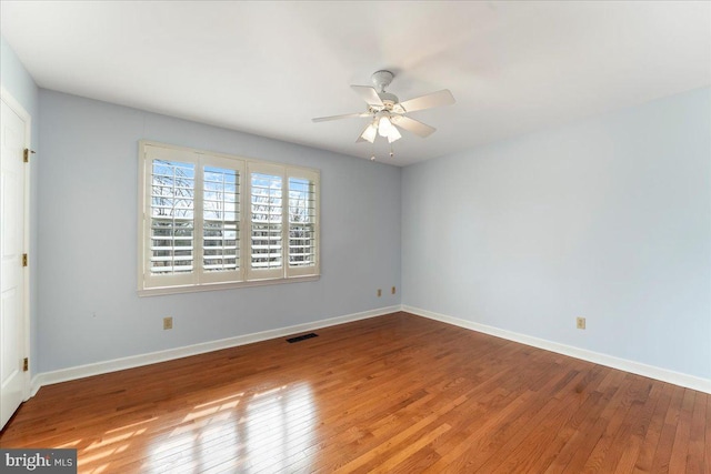 spare room featuring hardwood / wood-style floors and ceiling fan