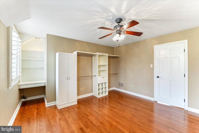 unfurnished bedroom with ceiling fan and light wood-type flooring