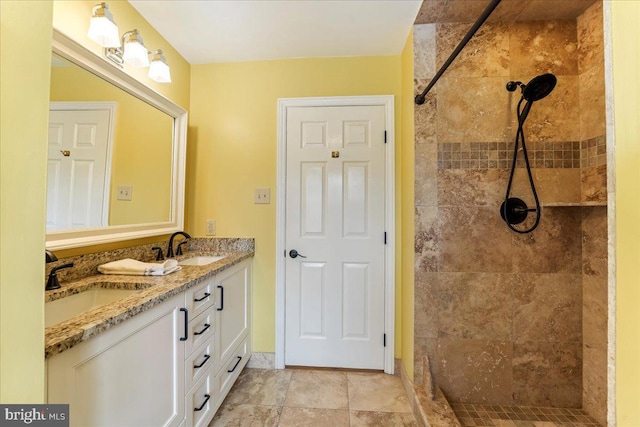 bathroom featuring vanity and tiled shower