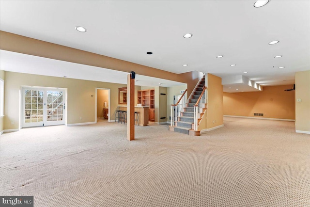 basement featuring light carpet