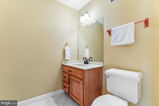 bathroom with tile patterned flooring, vanity, and toilet