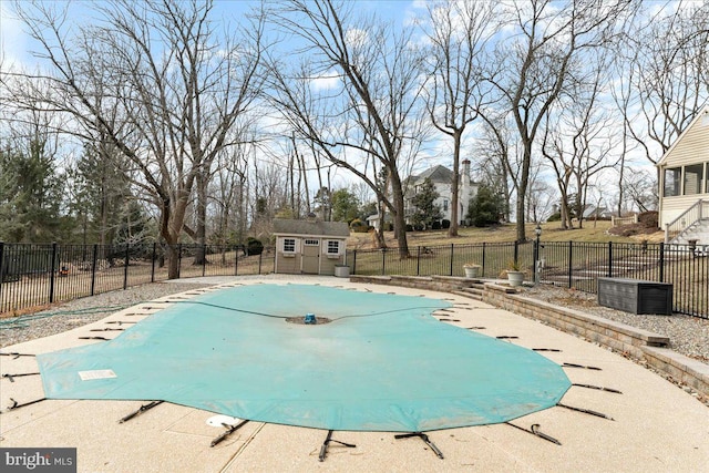 view of swimming pool featuring a shed