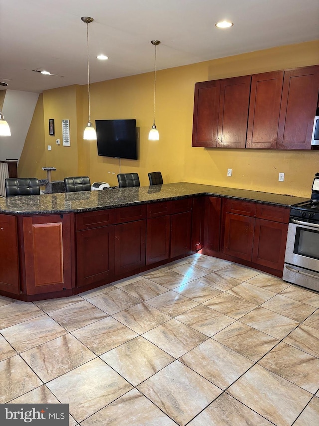 kitchen with kitchen peninsula, dark stone counters, decorative light fixtures, and appliances with stainless steel finishes