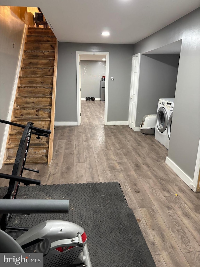 clothes washing area featuring washer and dryer and hardwood / wood-style floors