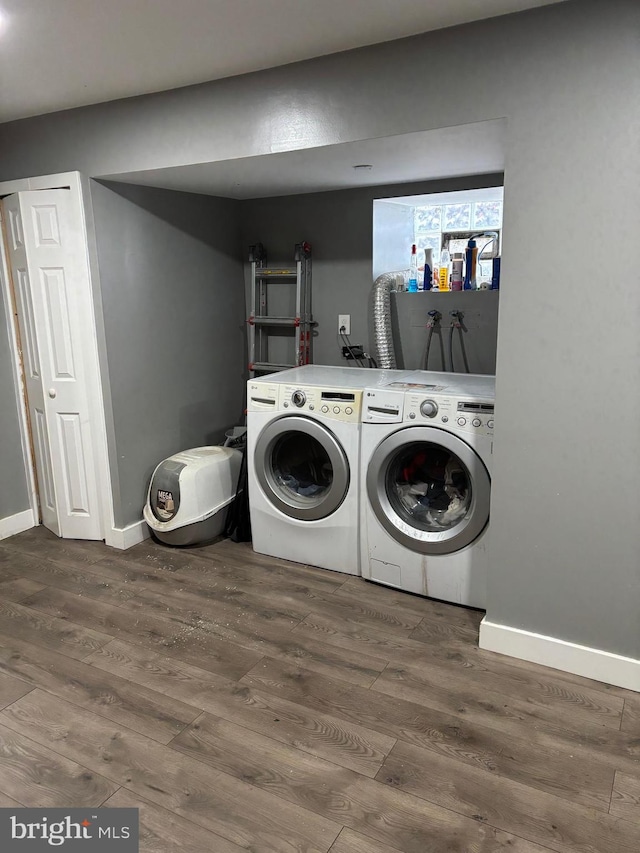 washroom featuring hardwood / wood-style floors and independent washer and dryer