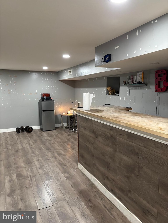 kitchen featuring stainless steel refrigerator and wood-type flooring