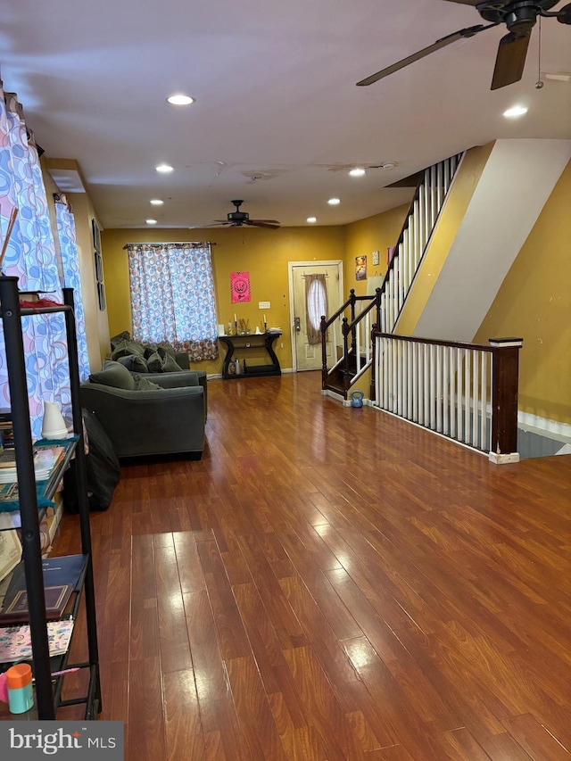 living room featuring ceiling fan and hardwood / wood-style floors